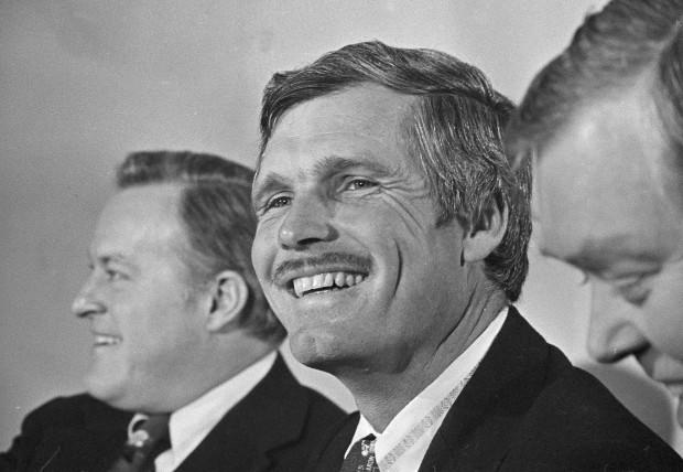 Ted Turner, Atlanta advertising and television executive, smiles after it was announced that he purchased the Atlanta Braves, Jan. 6, 1976, in Atlanta. Purchase price for the team was not disclosed but it was reportedly in the $10 million range. Turner is flanked by club chairman Bill Bartholomay, left, and president Dan Donahue. (AP Photo/Charles E. Kelly)