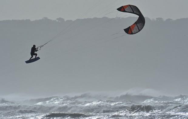 A kitesurfer gets 'big air' whilst competing in the British Kitesports Championships at Westward Ho! in north Devon, south west England October 17, 2012. 'Big air' is a term referring to a large jump utilising wind, kite, board speed and the lip of the wave. The competition lasts until October 20. REUTERS/Toby Melville (BRITAIN - Tags: SOCIETY SPORT)