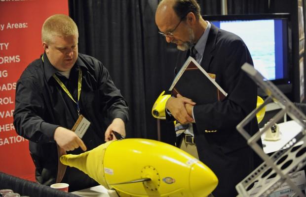 101109-N-7676W-172  ARLINGTON, Va. (Nov. 9, 2010) Michael Rufo, left, with Boston Engineering, explains the BIOSwimmer, a flexible hulled autonomous underwater vehicle, designed for high maneuverability in harsh environments, during day two of the Office of Naval Research 2010 Naval Science and Technology Partnership Conference. (U.S. Navy photo by John F. Williams/Released)